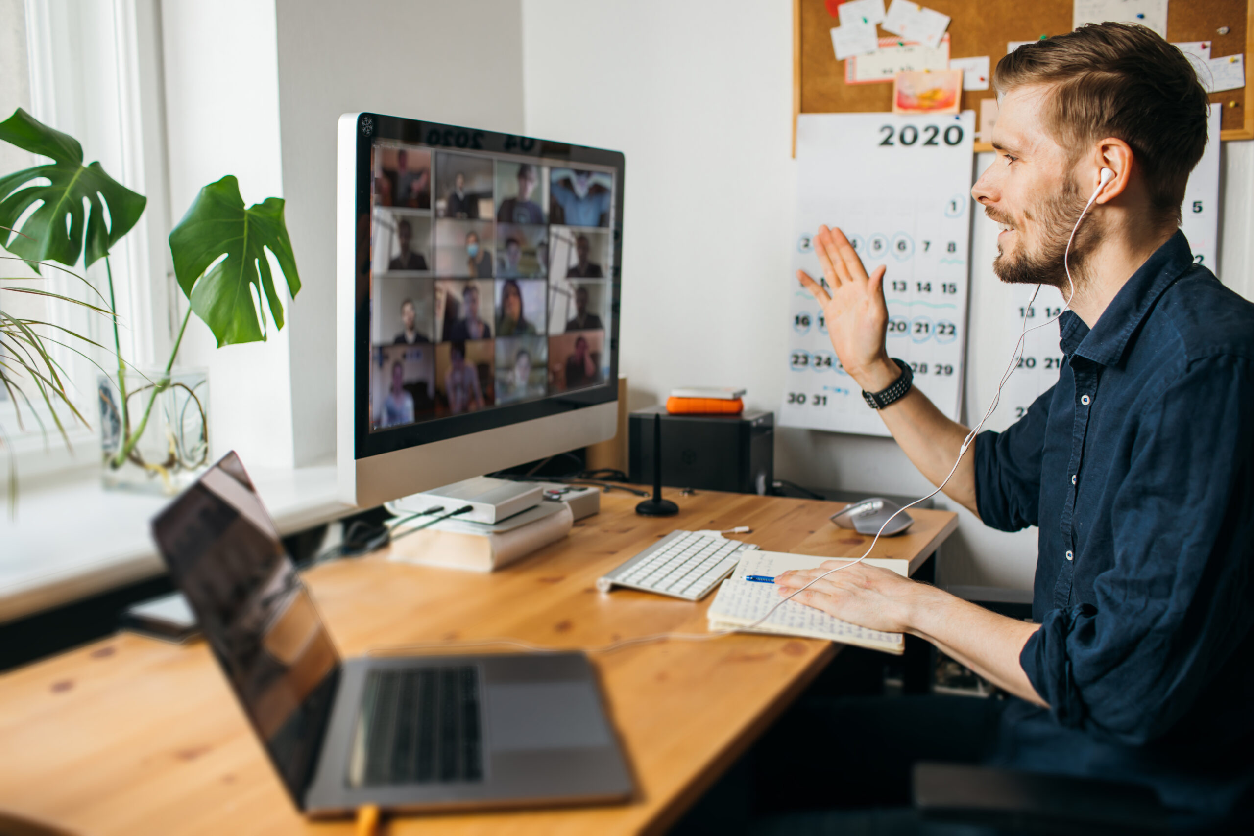 Man working from home, in a meeting on his computer